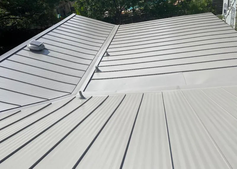 Solar attic fan installed on a metal roof for Roof Ventilation in Columbia Falls